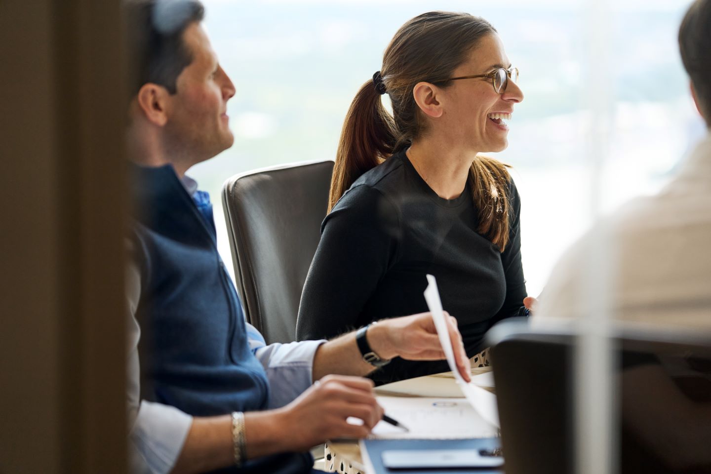 Two business professionals sitting at a conference table.