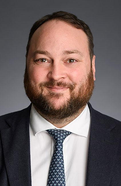 A professional headshot of Ben Williams