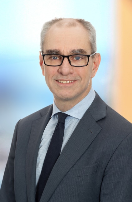 A professional headshot of Chris Blume