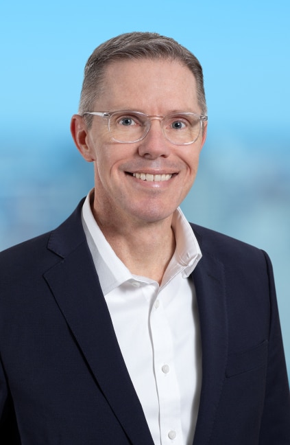 A professional headshot of Greg Furness