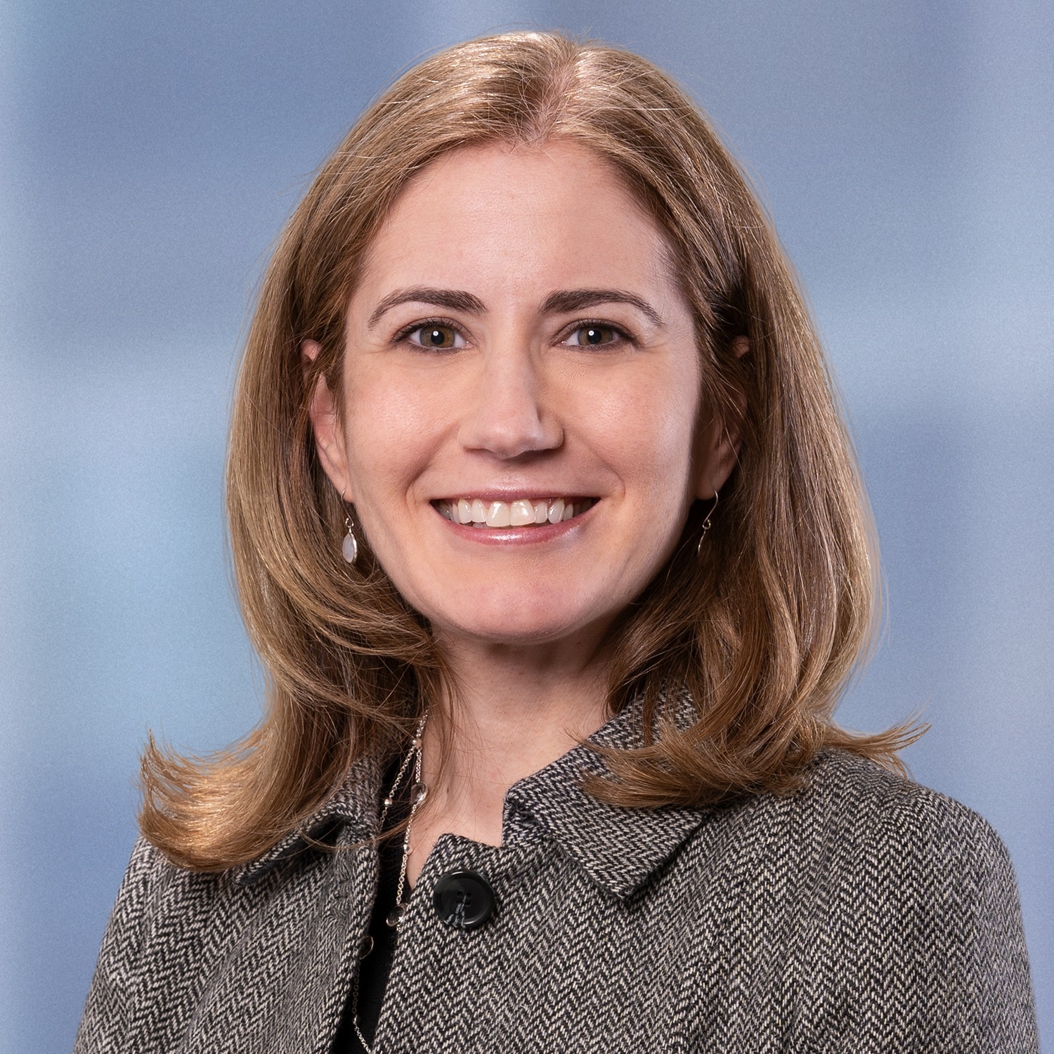 A professional headshot of Sarah Higgins