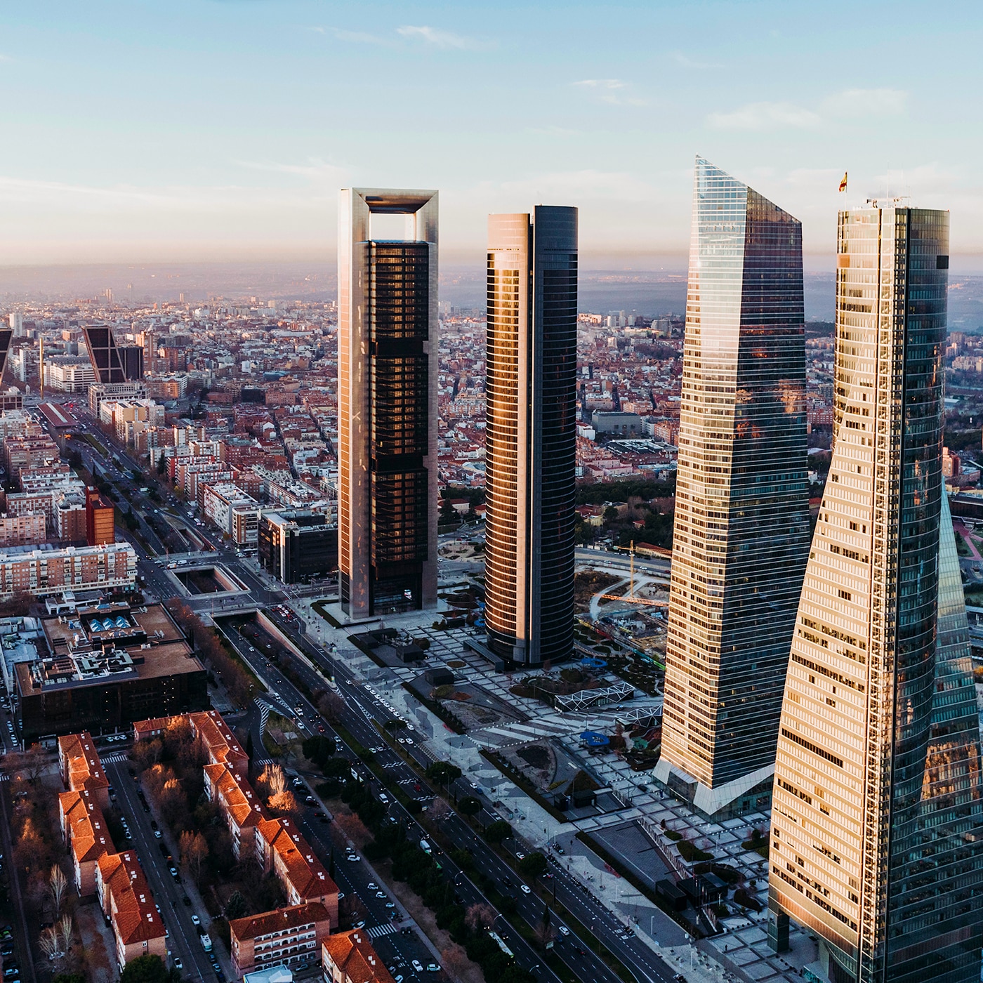 Aerial view of Madrid with the four skyscrapers of Cuatro Torres Business Area dominating the skyline.