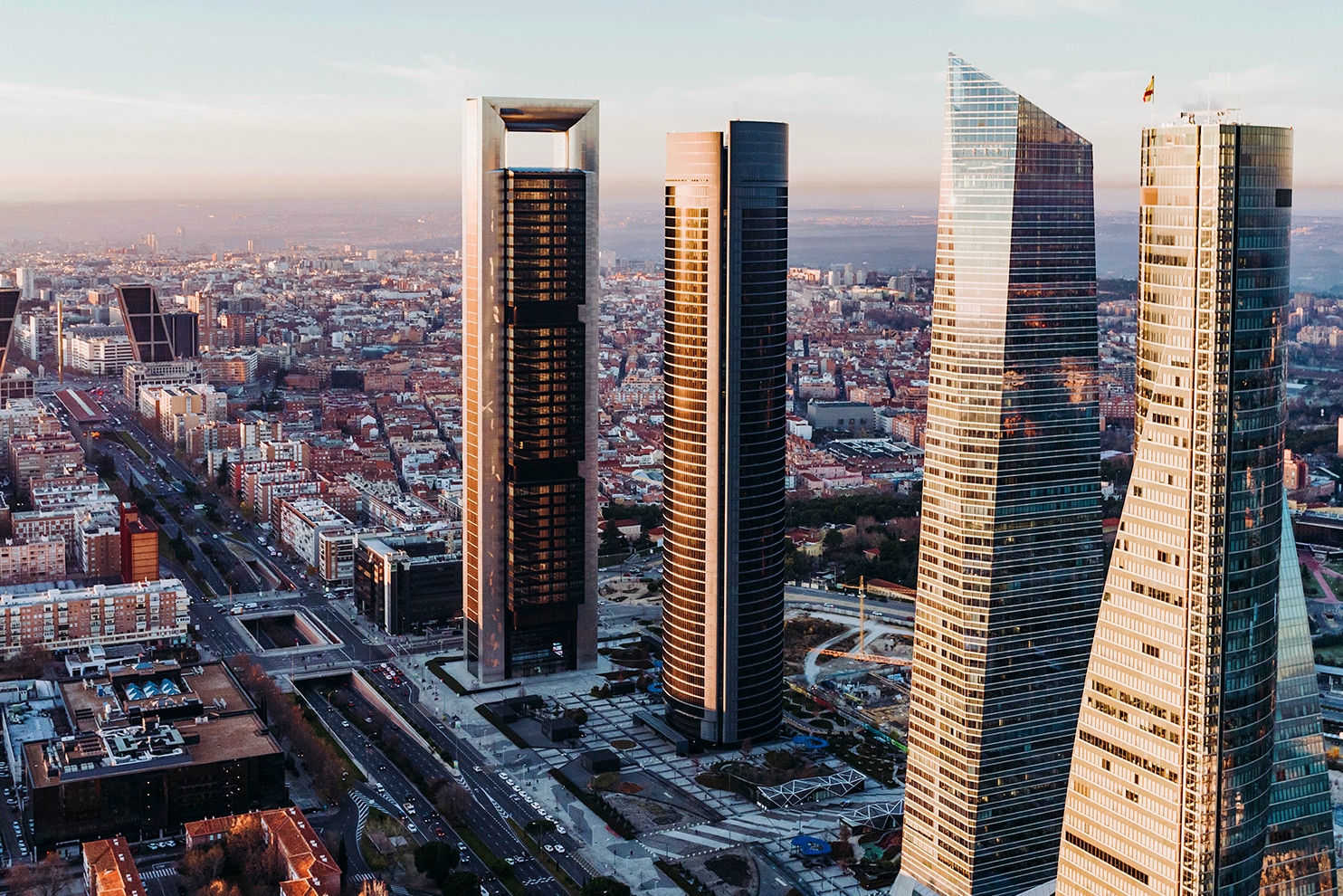 Aerial view of Madrid with the four skyscrapers of Cuatro Torres Business Area dominating the skyline.