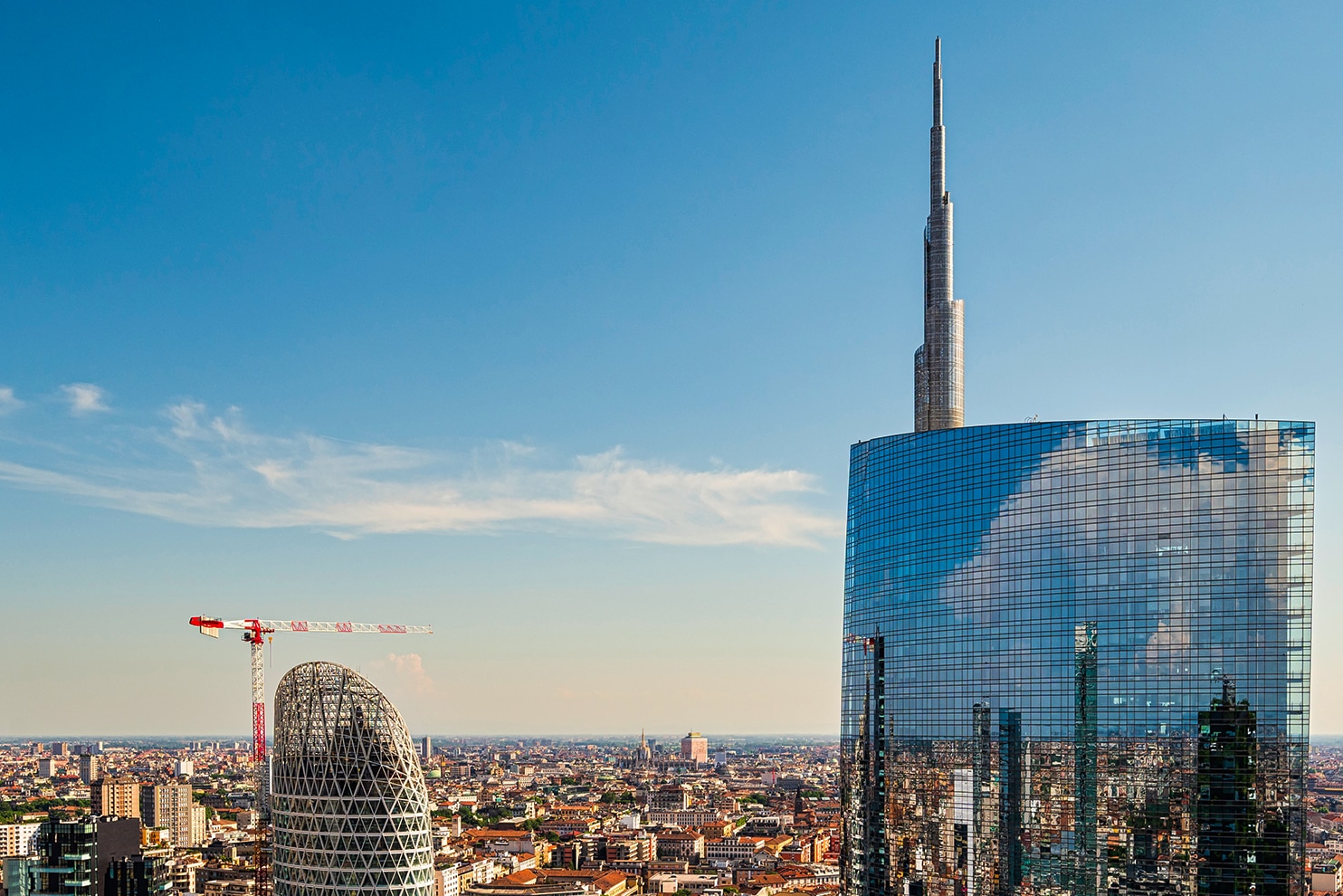 Modern skyscrapers reflecting the city skyline in Milan’s Porta Nuova business district.