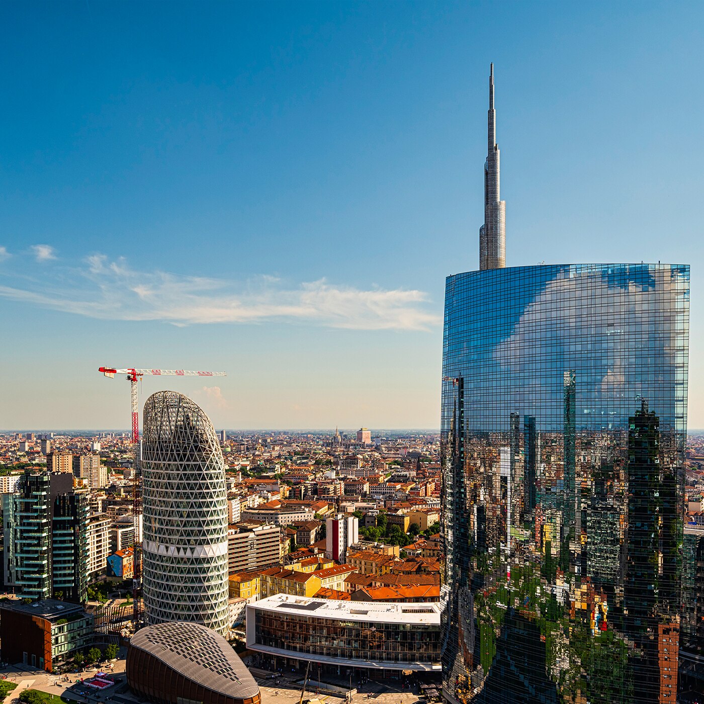 Modern skyscrapers reflecting the city skyline in Milan’s Porta Nuova business district.