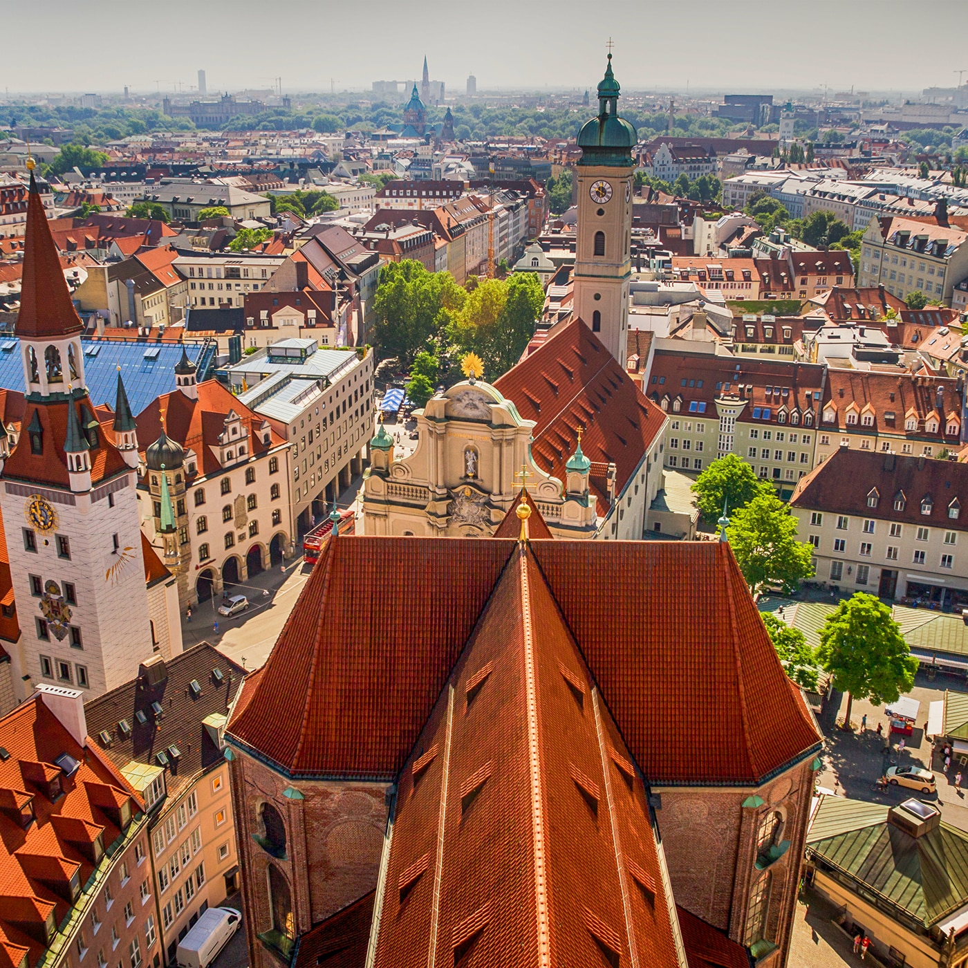 Rooftop view of Munich’s Old Town with red-tiled roofs and historic towers.