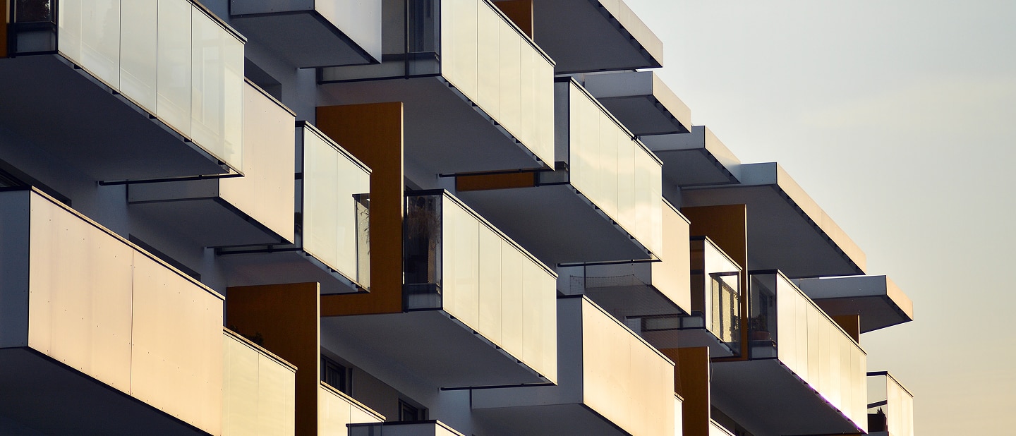 Abstract view of cantilevered glass apartment balconies.